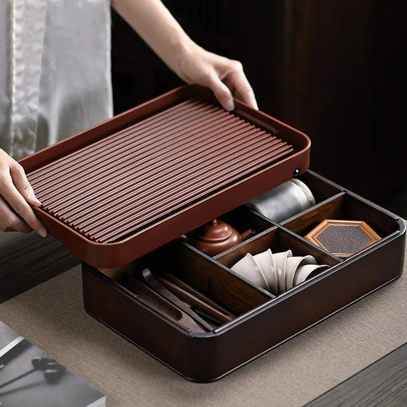 Lifted tea tray top showing the real storage compartments below