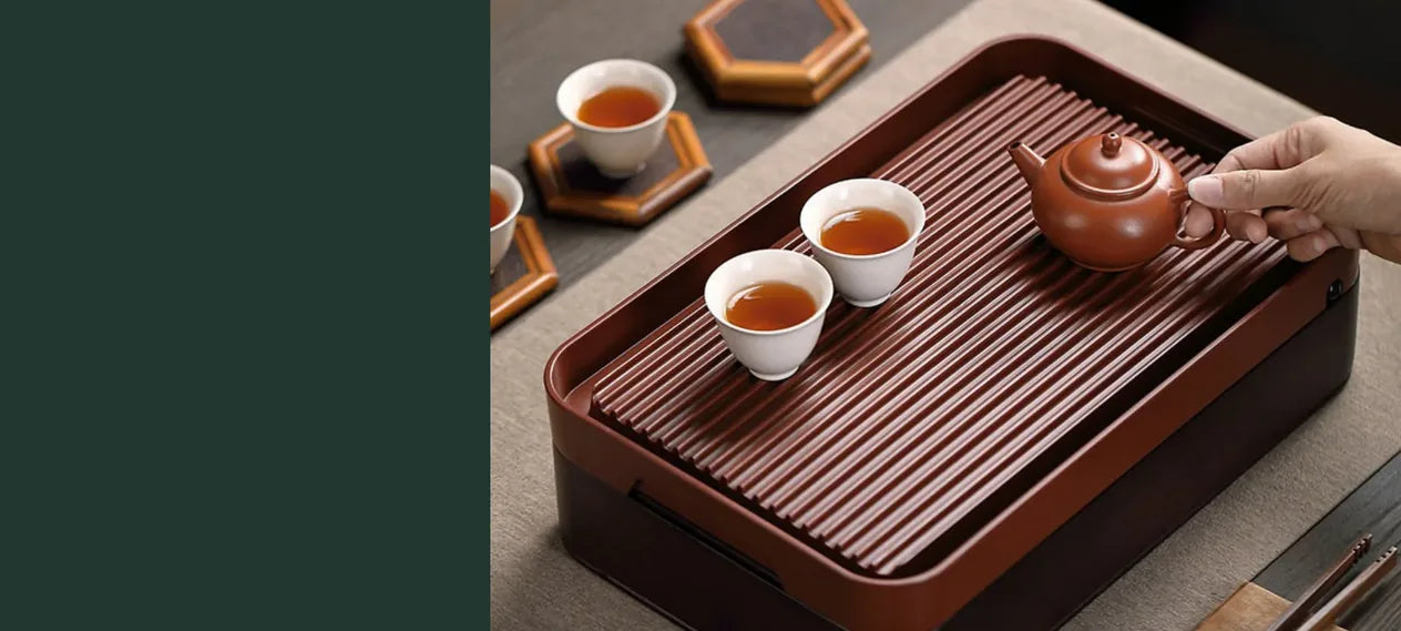 Chinese gongfu storage tea tray with a teapot and three tea cups arranged for serving